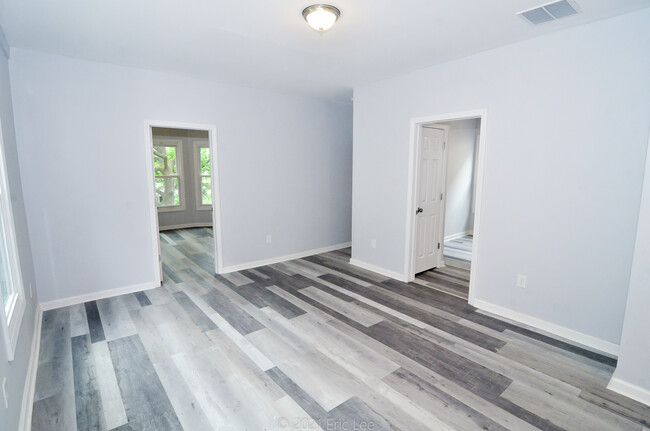 Main area looking towards the entrance (center hallway), bedroom 1 (left), and bedroom 2 (right). - 689 Winchester Ave