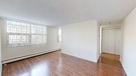 Located in the heart of Calgary, AB, this one-bedroom, one-bathroom unit offers a well-organized, single-floor layout designed to maximize functionality. Warm hardwood-style flooring runs continuously throughout, creating a cohesive and inviting atmosphere across all main living areas.

The entrance leads into a hallway that connects the key spaces of the unit. The living room is the largest area, featuring a full-height window fitted with vertical blinds that admit generous natural light and offer views of the surrounding urban cityscape. Baseboard heating runs along the walls, ensuring comfort year-round. The open sightlines and clean white walls contribute to a bright, airy feel.

The kitchen is positioned adjacent to the living area, equipped with white cabinetry, a white range, and a window that further enhances natural light. It provides efficient use of space for everyday meal preparation.

The bedroom offers a comfortable, cozy footprint with a sliding-door closet for storage, and a window with an urban outlook, keeping the room bright and connected to the city environment.

The bathroom is finished with classic white subway tile surrounding the bathtub and shower combination, complemented by a light stone-patterned countertop vanity and warm tile flooring, giving it a clean and timeless appearance.

Overall, this unit presents a practical and well-lit living space in a prime downtown Calgary location.