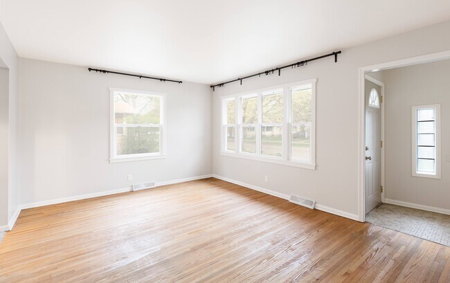 Freshly painted living room with original hardwood floors and tons of natural light! - 3116 28th Ave S