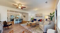 Located at 707 E Second Ave SW in Rome, GA, this two-story home offers a thoughtfully designed layout spread across two floors. The main level features an open-concept living and dining area bathed in natural light from large windows, with warm hardwood-style flooring and ceiling fans throughout. The living room provides a welcoming atmosphere with ample space for relaxing and entertaining.

The kitchen is a standout feature, boasting gray shaker-style cabinetry, granite countertops, a center island with bar seating, recessed lighting, and stainless steel appliances. A dedicated laundry room with full-size washer and dryer hookups adds everyday convenience on the main floor, alongside a well-appointed bathroom.

Upstairs, the generously sized primary bedroom features plush carpeting, a tray ceiling, a walk-in closet, and a private en-suite bathroom. Two additional bedrooms, each with ceiling fans and natural light, share access to the remaining bathrooms. Six closets throughout the home provide abundant storage.

Additional highlights include a patio for outdoor enjoyment, an attached garage with an automatic opener, and multiple hallways connecting the home's well-organized layout. With four bathrooms total and a functional two-floor design, this home balances comfort and practicality in every detail.