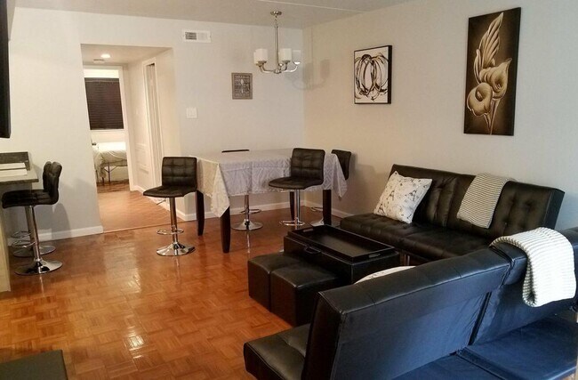 View from the living room towards the dining room table, which easily sits six people. - 516 S 12th St