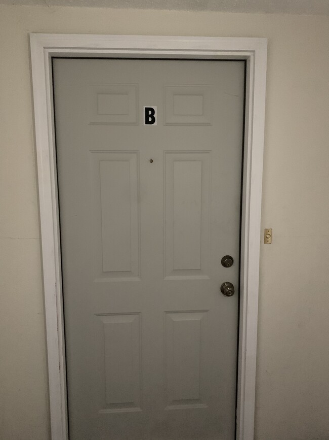 Entrance to apartment with steel door, deadbolt and doorbell - 513 W 36th St