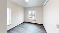 Located at 1120 S 11th St in Tacoma, Washington, this 3-bedroom, 2-bathroom unit is designed with a clean, modern aesthetic across a single floor. Wood-look plank flooring runs throughout the living areas and bedrooms, complemented by crisp white walls and dark baseboards that give the space a contemporary feel.

The kitchen is well-appointed with gray shaker-style cabinetry, light countertops, a stainless steel sink, a dishwasher, and a white electric range with overhead ventilation. Recessed lighting illuminates the workspace efficiently. Additional cabinetry provides generous storage for everyday needs.

The three bedrooms are bright and functional. Several rooms feature windows with views of the surrounding Tacoma neighborhood and open sky beyond, allowing natural light to fill the space. One bedroom includes a built-in closet rod for convenient storage. The primary bedroom, while compact, is thoughtfully laid out.

Two bathrooms serve the unit, both finished with neutral tones, light tile flooring, and accessible grab bars — reflecting a design that prioritizes comfort and usability. Vanities with under-sink storage are present in each bathroom.

Connecting the rooms are two hallways that contribute to an organized flow throughout the unit. The overall layout is efficient and well-structured, making this Tacoma residence a functional and modern living space.