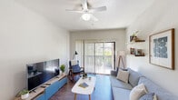 Located in Flagstaff, Arizona, this thoughtfully designed 2-bedroom, 2-bathroom single-story home offers a comfortable and functional layout. The living room serves as the heart of the space, featuring hardwood-style flooring, a ceiling fan, and a large sliding glass door framed by vertical blinds that opens to a private balcony with serene views of surrounding greenery. Floating shelves accent the walls, adding both character and practicality. The galley-style kitchen is well-appointed with warm wood cabinetry, ample counter space, and a full suite of white appliances including a range, microwave, refrigerator, and dishwasher. The primary bedroom is a comfortable retreat with a ceiling fan, large closet, and windows that let in natural light and tree-lined views. The second bedroom mirrors this warmth with its own window and ceiling fan. The primary bathroom features a dual-sink vanity with wood cabinetry and bright overhead lighting, while the second bathroom offers a shower-tub combination and a single vanity. Rich hardwood-style flooring flows consistently throughout the home, tying together a clean, cohesive aesthetic well-suited to Flagstaff's relaxed mountain-town character.