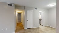 Located at 3920 Bell in Amarillo, Texas, this single-floor unit offers a well-designed layout that balances comfort and functionality throughout. The living area features light-toned wood-look flooring, neutral gray walls, and a stylish ceiling fan with built-in lighting. A large sliding glass door dressed with vertical blinds opens to an outdoor view, allowing generous natural light to fill the space.

The kitchen is equipped with granite countertops, an undermount double stainless steel sink, and gray cabinetry with brushed nickel hardware. A hallway connects the main living areas to the bedrooms and bathrooms, with a closet providing additional storage along the way.

The bedrooms are carpeted for comfort, each featuring ceiling fans and windows with horizontal blinds that frame pleasant outdoor greenery views. The bathroom includes a granite-topped vanity with gray cabinetry, a framed mirror, and brushed nickel fixtures, maintaining a consistent and cohesive design aesthetic throughout the unit.

Overall, the space presents a clean, updated interior with a neutral color palette, modern finishes, and practical storage solutions, making it a comfortable and move-in-ready home in Amarillo.