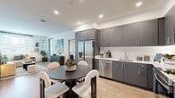Located at 14817 Foothill Blvd in Fontana, California, this thoughtfully designed two-bedroom, two-bathroom residence offers a contemporary single-floor layout with a clean, modern aesthetic throughout. Light wood-tone flooring flows seamlessly across the living areas, complementing the bright white walls and recessed lighting that give the space an open, airy feel.

The open-concept kitchen and dining area serves as the heart of the home, showcasing sleek gray flat-front cabinetry extending to the ceiling, white quartz countertops, a white subway tile backsplash, and a full suite of stainless steel appliances. A dedicated dining space adjacent to the kitchen provides an ideal setting for everyday meals or entertaining.

The living room is well-proportioned and sun-filled, benefiting from a large window that invites natural light. A private balcony extends the living space outdoors. The primary bedroom is a comfortable retreat with a window, dedicated closet, and an en-suite bathroom featuring a bold blue vanity with white countertops and wood-look flooring. The second bedroom is equally bright with generous window coverage. The second bathroom offers a charcoal-toned vanity with matching hardware. An in-unit laundry area and hallway complete the thoughtful floor plan.