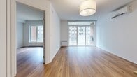 Located at 329 Boul Hymus in Pointe-Claire, Quebec, this well-designed one-bedroom, one-bathroom unit offers a thoughtful layout across a single floor. The modern kitchen is a standout feature, equipped with stainless steel appliances including a full-size refrigerator and electric range, crisp white cabinetry, and a peninsula with a built-in sink — ideal for both cooking and casual dining. Light hardwood flooring flows throughout the unit, lending warmth and continuity to the space. The open living area is bright and inviting, benefiting from large sliding glass doors and windows that frame views of the surrounding neighbourhood and allow generous natural light to fill the room. The bedroom is a clean, minimalist space with a window overlooking the exterior, complemented by a closet for storage. The bathroom is finished with neutral tile, a combined tub and shower, a vanity with under-sink storage, and a large mirror. A dedicated in-unit laundry room adds everyday convenience, complete with a full-size washer and dryer and overhead wire shelving. Two hallways connect the rooms efficiently, contributing to the unit's practical and functional flow. The overall aesthetic is modern and neutral, making it a comfortable and move-in ready space.