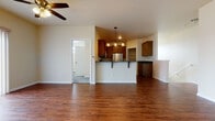 Located in Madison, WI, this two-floor property offers a well-designed layout with functional living spaces spread across both levels. The main living area features rich hardwood-style flooring and a ceiling fan, creating a comfortable, open atmosphere. The kitchen is thoughtfully designed with warm wood cabinetry, dark granite countertops, a peninsula breakfast bar with seating, and a full suite of stainless steel appliances including a refrigerator, range, over-the-range microwave, and dishwasher. A pendant light fixture above the peninsula adds a stylish focal point. Adjacent to the kitchen, a dedicated closet houses a stacked washer and dryer, providing convenient in-unit laundry access. The bedrooms are carpeted and bright, with natural light entering through windows fitted with blinds; one bedroom includes a wall-mounted climate control unit. Closet space is well-represented, with double-door closets offering built-in hanging rods. The bathroom is finished with tile flooring, a rich wood vanity, dark granite countertop, and a well-lit mirror. The attached single-car garage features a concrete floor, automatic door opener, and a side window for natural light, adding practical storage and parking convenience.