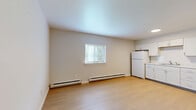 Located at 30 Black Creek Rd in Esopus, NY, this two-bedroom, one-bathroom unit offers a thoughtfully laid-out single-floor design. The open living and kitchen area is finished with light wood-tone flooring that creates a clean, bright atmosphere. The kitchen is equipped with white shaker-style cabinetry, a subway tile backsplash, stainless steel range and microwave, and a white refrigerator, all set against a neutral color palette. A window with blinds allows natural light to fill the combined living space, which also features baseboard heating for consistent warmth. A hallway connects the main living area to the rest of the unit, providing a clear and functional layout. Both bedrooms are carpeted for comfort and each includes a closet—one with a sliding door and another with a double-door configuration. The bedrooms are bright, with windows that let in natural light, and are serviced by the same baseboard heating system. The bathroom is clean and straightforward, featuring a full shower-tub combination, toilet, and light wood flooring. Overall, the unit presents a simple, well-maintained interior suited for comfortable everyday living in the Hudson Valley region of New York.