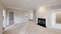 This 1170 square foot apartment in Charlotte, NC offers a blend of comfort and style. The space comprises two bedrooms, including a primary bedroom of 210 square feet, and three bathrooms, providing ample privacy and convenience. The single-floor layout maximizes accessibility and flow.

The living room is bathed in natural light, thanks to large windows with white blinds. Plush carpeting and neutral wall colors create a warm, inviting atmosphere. The modern kitchen boasts white cabinetry, granite countertops, and stainless steel appliances, perfect for culinary enthusiasts.

Bathrooms feature a mix of designs, some with tub-shower combinations and others with separate tubs and showers. Wooden flooring in some bathrooms adds a touch of elegance. The apartment includes a walk-in closet with wire shelving, offering generous storage space.

A standout feature is the balcony, which provides picturesque views of the surrounding landscape, including mature trees and manicured grounds. This outdoor space is ideal for relaxation or entertaining.

Crown molding, recessed lighting, and a ceiling fan in the bedroom contribute to the overall refined aesthetic. The apartment's neutral color palette allows for easy personalization, making it a versatile canvas for various decorating styles.