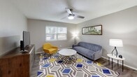 Located at 2513 Lynnwood Dr in Arlington, TX, this single-story 2-bedroom, 1-bathroom home offers a well-designed layout with modern updates throughout. The living room serves as the heart of the home, featuring hardwood-style flooring, a ceiling fan, and a window that invites natural light, creating a bright and welcoming atmosphere. The kitchen is thoughtfully updated with crisp white shaker cabinets, granite countertops, a classic subway tile backsplash, a stainless steel sink, and a dishwasher, making it both functional and stylish. Both bedrooms are carpeted for comfort and equipped with ceiling fans. The primary bedroom offers a generous footprint with a closet and windows providing natural light. The second bedroom features a tall upholstered headboard and ample space for relaxation. The shared bathroom includes a tub-shower combination finished with large-format gray tile and a built-in corner shelf, offering a clean, modern aesthetic. A connecting hallway ties the rooms together efficiently. Neutral tones and consistent finishes throughout give this home a cohesive, move-in-ready feel well-suited for comfortable everyday living.