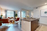 Located at 3461 La Cadena Dr in Riverside, CA, this well-appointed 2-bedroom, 2-bathroom single-story home offers a thoughtfully designed layout with modern finishes throughout. The open-concept living, dining, and kitchen area serves as the heart of the home, featuring light wood-look flooring, large windows with blinds that invite abundant natural light, and a striking statement wall. The kitchen is equipped with stainless steel appliances, two-tone cabinetry in teal and rich wood tones, a subway tile backsplash, and a center island with bar seating — ideal for casual dining and entertaining. The primary bedroom is a comfortable retreat with carpet flooring, natural light, and a dedicated walk-in closet with wire shelving. Both bathrooms are clean and functional, with one featuring a full tub-shower combo, wood-toned vanity, and wood-look tile flooring. Additional highlights include an in-unit laundry area, a connecting hallway for privacy between rooms, and a private patio perfect for outdoor relaxation. The attached garage provides convenient and secure parking. This home combines practical living spaces with contemporary design details throughout.