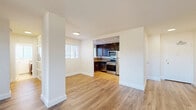 Located on Wilshire Boulevard in the heart of Los Angeles, this well-appointed one-bedroom, one-bathroom residence offers a thoughtfully designed single-floor layout. Hardwood-style flooring flows seamlessly throughout the living areas, creating a warm and cohesive aesthetic. The open-concept living and dining room is bright and spacious, with large windows dressed in plantation shutters that invite generous natural light and offer pleasant outdoor views. A hallway connects the main living space to the private bedroom and bathroom. The kitchen is efficiently designed and features rich dark wood cabinetry, granite countertops with a stone tile backsplash, granite tile flooring, and a full suite of stainless steel appliances including a gas range, dishwasher, microwave, and refrigerator. The generously sized bedroom accommodates a comfortable layout, with large windows providing natural light and a mirrored sliding-door closet that enhances the sense of space. Additional storage is provided by three closets throughout the unit. The bathroom is finished with a granite-topped vanity, matching dark wood cabinetry, and bright windows. Clean white walls and modern finishes throughout contribute to a fresh, move-in-ready ambiance in this prime Westside Los Angeles location.