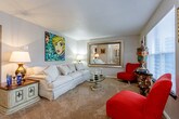 Located at 2940 SW Gage Blvd in Topeka, Kansas, this single-floor residence offers a well-organized layout across a comfortable and functional footprint. The living room serves as the heart of the home, featuring warm carpeted flooring, a textured ceiling, and neutral walls that create a welcoming atmosphere. A large framed mirror adds depth to the space, while a pass-through window connects the living area to the dining room, promoting an open and airy feel throughout.

The dining area is bright and inviting, benefiting from a large window that allows natural light to fill the room. A ceiling fan adds comfort to this tiled space, which is well-suited for everyday dining. Adjacent to the dining room, the kitchen is outfitted with dark cabinetry, granite countertops, tile flooring, and stainless steel appliances including an electric range and an over-the-range microwave.

The bedroom is generously sized with plush carpeting and features a walk-in closet, offering ample storage. Two bathrooms are present in the home, each finished with tile flooring, dark vanity cabinetry, white countertops, and framed mirrors with overhead lighting — one featuring full wall tile surround. The overall design is cohesive, practical, and move-in ready.