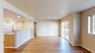 Located at 985 N Maple Grove in Boise, Idaho, this single-floor space offers a clean, functional layout with a neutral color palette and an abundance of natural light throughout. The main living area is generously proportioned, featuring smooth hardwood-style flooring, recessed lighting, and a textured ceiling. A large sliding glass door opens to an outdoor view, flooding the space with natural light and providing direct exterior access. An additional window further enhances the bright, airy atmosphere of the living area.

A half-wall partition separates the living space from the kitchen, which features light wood cabinetry, light-toned countertops, and recessed overhead lighting. The kitchen is equipped with a range and ventilation hood, providing a practical and efficient cooking area.

The bedroom is carpeted for comfort and includes multiple windows that invite natural light and outdoor views. A separate room features plush carpet and a single window with vertical blinds.

The bathroom is equipped with a full soaking tub and shower combination with chrome fixtures. Conveniently located nearby is an enclosed laundry area housing a full-sized washer and dryer, along with overhead shelving for additional storage. The overall ambiance of the space is clean, bright, and move-in ready.