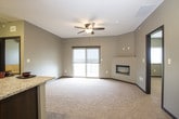 This single-floor unit presents a cohesive, contemporary design throughout its well-organized layout. The kitchen is a standout space, featuring dark espresso cabinetry extending to the ceiling for ample storage, granite countertops, black appliances, and light hardwood flooring. A peninsula counter with additional seating space connects the kitchen to the carpeted living area, creating an open, functional flow from the entry door.

The bedrooms are carpeted and finished with neutral-toned walls. One bedroom benefits from a sliding glass door that opens to a private balcony, offering outdoor views and enhanced natural light. A ceiling fan adds to the comfort of this room. Additional bedrooms feature windows with blinds that bring in natural light.

Two full bathrooms serve the unit. One includes a tub-shower combination with a curved curtain rod, dark vanity cabinetry, granite countertops, and large-format tile flooring. The second bathroom mirrors the same design language with a walk-in shower, a similarly styled dark vanity with granite countertop, a large mirror, and matching tile flooring. Both bathrooms maintain a consistent, modern aesthetic with chrome fixtures and neutral wall tones throughout.