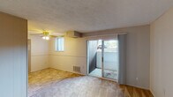 Located at 6725 Shenandoah Dr in Florence, Kentucky, this single-floor unit offers a straightforward, functional layout spread across several connected rooms. The living area serves as the central gathering space, featuring a ceiling fan, a textured ceiling, and a mix of carpet and hard flooring. A set of sliding glass doors provides direct access to an outdoor patio area, while a secondary window allows additional natural light to filter into the room.

The kitchen is outfitted with white cabinetry featuring arched detailing, a double-basin stainless steel sink, and light-toned countertops. Tile flooring runs through this area, offering a practical, easy-to-maintain surface. Ample upper cabinet storage makes the space efficient for everyday use.

The bedrooms are carpeted and neutrally finished, with one room featuring a closet accessed through a paneled door, providing useful storage. The rooms offer a blank canvas suitable for various furniture arrangements.

The bathroom includes a full tub and shower combination with a curtain rod, a toilet, and a vanity with under-sink storage. Tile flooring completes the space with a clean, utilitarian appearance. Overall, the unit presents a practical and livable layout in a residential Florence neighborhood.