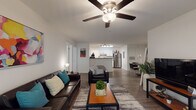 Located at 3101 Compatible Way in Raleigh, NC, this single-floor residence offers a well-designed, open layout that promotes a comfortable and functional living experience. The spacious living room serves as the heart of the home, featuring wood-style plank flooring, a ceiling fan, and an open sightline into the kitchen and dining area, creating a seamless flow throughout the main living space. Natural light filters in through windows dressed with sheer curtains, brightening the interior.

The kitchen is outfitted with white cabinetry, dark granite-style countertops, and stainless steel appliances including a refrigerator, range, dishwasher, and microwave. The galley-style layout maximizes counter and storage space, with access to a utility area.

The bedrooms are carpeted and comfortably sized, each featuring ceiling fans, windows with blinds, and ample room for standard furnishings. The rooms offer a quiet, private retreat within the home.

The bathrooms are clean and functional, each featuring a tub/shower combination, wood-style flooring, white cabinetry with dark countertops, and large mirrors. The overall design is consistent and modern throughout, with a neutral color palette that adds to the bright, welcoming ambiance of the space.