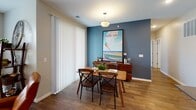 Located at 14820 Piper Ln in Grand Haven, Michigan, this single-floor residence offers a thoughtfully designed layout with a cohesive coastal-inspired aesthetic throughout. The open-concept living and dining area serves as the heart of the home, highlighted by rich wood-look flooring, a bold teal accent wall, and large vertical blinds that allow ample natural light. The living room features a comfortable seating arrangement, while the adjacent dining space is anchored by a statement Grand Haven Beach artwork, adding a local sense of place.

The kitchen is well-equipped with crisp white shaker cabinetry, dark countertops, stainless steel appliances including a range, built-in microwave, and refrigerator, all set over durable wood-look flooring. A breakfast bar provides additional seating and connects the kitchen to the main living area.

The bedrooms are carpeted and serene, each offering natural light through windows and tasteful decor with beach-themed artwork. The bathrooms are clean and functional, featuring white vanity cabinetry, a tub-shower combination, and wood-look flooring. A long, corridor-style en-suite bathroom with extended white cabinetry adds practical storage. Throughout the home, a neutral color palette and consistent finishes create a calm, welcoming ambiance suited to the lakeside community.