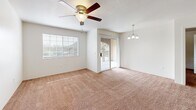 Located on W Broadway Blvd in Tucson, Arizona, this single-floor, 2-bedroom, 2-bathroom unit offers a functional and well-organized layout. The open living room is finished with plush carpeting, a ceiling fan with light fixture, a textured ceiling, and a sliding glass door that opens to a private balcony with outdoor views. A large window allows natural light to fill the space. An elegant chandelier adds an additional design touch near the dining area.

The kitchen features wood-look flooring, light gray cabinetry, stainless steel appliances including a refrigerator, electric range, and built-in microwave, along with a granite-style countertop and a built-in sink. A dedicated laundry closet with a full-size washer and dryer is conveniently accessible from the kitchen.

Both bedrooms are carpeted and feature large windows with blinds that offer views of the surrounding landscape. Each room includes a closet for storage. The two bathrooms are clean and efficiently designed, each offering a tub/shower combination, a vanity with granite-style countertop, and wood-look flooring. This unit provides a comfortable and practical living environment in a well-established Tucson neighborhood.