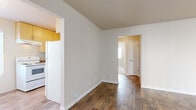 Located at 1420 F Street in Davis, CA, this one-bedroom, one-bathroom unit offers a well-organized single-floor layout designed for comfortable everyday living. The living room is an open, inviting space finished with rich wood-look flooring and neutral-toned walls, complemented by a wall-mounted mini-split air conditioning unit for year-round comfort. A sliding glass door with vertical blinds allows natural light to filter in and provides access to the outdoors. The kitchen is efficiently arranged in a U-shaped layout, featuring warm honey-toned upper cabinetry, lighter lower cabinets, dark laminate countertops, and white appliances including a freestanding electric range with overhead ventilation. Wood-look flooring continues seamlessly through this space. The bedroom is a cozy, well-proportioned room with plush carpeting, warm beige walls, and a window with blinds that brings in natural light and outdoor views. A dedicated closet provides practical storage. The bathroom is clean and functional, offering a full bathtub and shower combination with tile surround, a white vanity, and a frosted window for natural light and privacy. Neutral tones throughout the unit create a calm, cohesive ambiance.