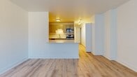 Situated on North Clark Street in Chicago's vibrant Lincoln Park neighborhood, this single-floor residence offers a thoughtfully designed layout with updated finishes throughout. Light-toned hardwood flooring runs continuously through the main living areas, contributing to a cohesive and airy feel.

The living area is generously proportioned, featuring a large window dressed with vertical blinds that allows natural light to fill the space. A wall-mounted HVAC unit and baseboard heating provide climate control year-round.

The kitchen is designed for functionality and style, featuring gray shaker-style cabinetry with brushed hardware, white quartz countertops, and a classic subway tile backsplash. Stainless steel appliances — including a gas range, microwave, and refrigerator — are complemented by a single-basin sink with a modern arc faucet. A peninsula with a breakfast bar connects the kitchen to the living area, enhancing the open-concept flow.

A built-in shelving unit and additional closet storage provide practical organization options along the hallway corridor.

The bathroom is finished with floor-to-ceiling white subway tile surrounding a soaking tub and shower combination. Brushed nickel fixtures, a white vanity with a clean countertop, and neutral tile flooring complete the polished, contemporary look.