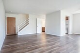 Located at 6806 Tottenham Rd in Madison, WI, this two-bedroom, two-bathroom home spans two floors, offering a comfortable and functional layout. The main floor features a bright and open living room with durable hardwood-style flooring, neutral white walls, a ceiling fan, and a large window that fills the space with natural light and views of the surrounding neighborhood. A staircase connects the two levels seamlessly.

The kitchen is well-appointed with rich dark wood cabinetry, light granite-style countertops, and stainless steel appliances including a refrigerator, dishwasher, and electric range. A wide window above the double sink frames pleasant outdoor views, and a convenient built-in pantry provides ample storage space.

Upstairs, the spacious primary bedroom features plush carpeting, bright neutral walls, and direct access to both a closet and an adjoining bathroom. The second bedroom is also carpeted and receives generous natural light through a well-positioned window. Both bathrooms are clean and functional, each featuring a single-sink vanity with a large mirror, white countertops, dark wood cabinetry below, and well-lit surroundings. The overall ambiance of the home is bright, clean, and move-in ready.