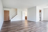 Located at 6806 Tottenham Rd in Madison, WI, this two-bedroom, two-bathroom home spans two floors, offering a comfortable and functional layout. The main floor features a bright and open living room with durable hardwood-style flooring, neutral white walls, a ceiling fan, and a large window that fills the space with natural light and views of the surrounding neighborhood. A staircase connects the two levels seamlessly.

The kitchen is well-appointed with rich dark wood cabinetry, light granite-style countertops, and stainless steel appliances including a refrigerator, dishwasher, and electric range. A wide window above the double sink frames pleasant outdoor views, and a convenient built-in pantry provides ample storage space.

Upstairs, the spacious primary bedroom features plush carpeting, bright neutral walls, and direct access to both a closet and an adjoining bathroom. The second bedroom is also carpeted and receives generous natural light through a well-positioned window. Both bathrooms are clean and functional, each featuring a single-sink vanity with a large mirror, white countertops, dark wood cabinetry below, and well-lit surroundings. The overall ambiance of the home is bright, clean, and move-in ready.