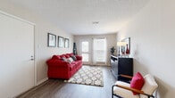 This efficiently designed 1-bedroom, 1-bathroom unit offers a thoughtful layout across a single floor, making excellent use of its compact footprint. The combined living and dining area serves as the heart of the unit, featuring durable wood-look flooring, a textured ceiling, and a sliding glass door that opens to a private balcony, filling the space with natural light and outdoor views. The dining area is defined by a classic chandelier overhead and flows seamlessly into the living space, creating an open and connected atmosphere.

The kitchen is well-equipped with warm wood cabinetry, dark granite-style countertops, stainless steel appliances, and a peninsula that provides additional prep space and a natural separation from the main living area. A dedicated laundry space adds everyday convenience.

The bedroom offers a comfortable, carpeted retreat with ample natural light from a large window dressed with blinds and curtains. A dedicated closet provides practical storage. The full bathroom features warm wood vanity cabinetry, a granite-style countertop, a large mirror, and a tiled shower-tub combination. Throughout the unit, neutral tones and consistent finishes create a cohesive, move-in-ready living environment.