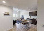 Located at 6350 Griffin Rd in Davie, Florida, this single-floor residence offers a thoughtfully designed layout with a clean, contemporary aesthetic throughout. The open-plan living and dining area is anchored by light wood-tone flooring, crisp white walls, and a ceiling fan, creating a bright and comfortable gathering space. Natural light flows in through sizable windows fitted with blinds, offering pleasant outdoor views.

The kitchen is well-appointed with dark espresso cabinetry, granite countertops, and a full suite of stainless steel appliances including a refrigerator, range, microwave, and dishwasher. It connects seamlessly to the dining area, making the space ideal for everyday living.

Multiple bedrooms provide comfortable private retreats, each featuring wood-tone flooring, ceiling fans, and windows with outdoor views. One bedroom includes a built-in shelving and desk unit, offering an efficient workspace alongside sleeping quarters — a functional detail well-suited for students or remote workers.

The bathrooms are finished with neutral tile flooring and feature glass-enclosed walk-in showers. One bathroom includes a vanity with dark cabinetry and granite countertop, while another offers a more streamlined design. The overall ambiance of the unit is modern, clean, and practical, reflecting a well-maintained living environment in a convenient South Florida location.
