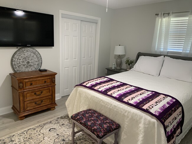 Master bedroom has wall mounted television, ceiling fan - 1301 E Leonard St