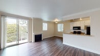 Located at 11983 Wellworth Ave in the desirable Westwood neighborhood of Los Angeles, CA, this single-floor unit offers a well-appointed and functional layout throughout. The living area is a standout feature, showcasing rich dark hardwood flooring that flows seamlessly through the space, complemented by elegant crown molding and a classic white fireplace that serves as a natural focal point. Large sliding glass doors open to a private balcony, allowing abundant natural light to fill the room and offering pleasant views of the surrounding neighborhood greenery. Multiple windows fitted with vertical blinds further enhance the bright and airy ambiance.

The kitchen is positioned in an open-concept arrangement adjacent to the living area, featuring white cabinetry, granite-toned countertops, a double stainless steel sink, and black appliances including a refrigerator, range, microwave, and dishwasher. This layout creates an inviting flow between cooking and living spaces.

The bedroom continues the hardwood flooring theme and includes a window with natural light, while a textured ceiling adds a subtle design detail. The bathroom is clean and functional, equipped with a full tub-shower combination, a vanity with mirror, and consistent hardwood-style flooring, maintaining a cohesive aesthetic throughout the unit.