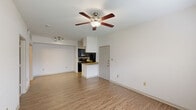 This one-bedroom, one-bathroom unit in Lake Charles, Louisiana, offers a practical and functional layout across a single floor. The open living area is bright and welcoming, featuring wood-look plank flooring, a ceiling fan with light fixture, and neutral white walls that create a clean, airy atmosphere. Multiple windows fitted with blinds allow natural light to fill the space.

The kitchen is a standout feature, designed in a galley style with dark cabinetry, granite countertops, a subway tile backsplash, and black appliances including a refrigerator, electric range, and microwave. A peninsula counter with granite top connects the kitchen to the living area, providing additional workspace and a casual dining option. Track lighting and a window enhance visibility and ambiance in the kitchen.

The bedroom is a comfortable size, finished with plush carpeting, a ceiling fan, and a window that brings in natural light. A dedicated closet provides storage.

The bathroom includes a tub-shower combination with tiled surround and wood-look flooring. The unit also features a textured ceiling in select areas and convenient HVAC vents throughout, ensuring year-round comfort.