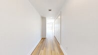 Located at 1626 Edison St in Dallas's vibrant Design District, this contemporary 2-bedroom, 2-bathroom residence offers a thoughtfully designed single-level layout with high-end finishes throughout. The open-concept kitchen and living area serves as the heart of the home, featuring crisp white cabinetry with gold hardware, a large quartz waterfall island, stainless steel appliances, and warm wood-look flooring that flows seamlessly throughout the space. Pendant lighting with brass accents adds a refined touch overhead.

The living area is defined by dramatic floor-to-ceiling glass walls that flood the space with natural light and frame sweeping views of the Dallas skyline. A curved architectural column and track lighting lend a modern, gallery-like quality to the room. Sliding glass doors provide direct access to a spacious outdoor terrace, extending the living experience outdoors with panoramic city views.

The generously sized primary bedroom continues the floor-to-ceiling window theme, offering abundant natural light and skyline vistas. It includes dedicated closet space with built-in shelving. The primary bathroom is elegantly appointed with a soaking tub, glass-enclosed walk-in shower, dual-sink marble vanity, and warm tile flooring. The second bedroom is bright and well-proportioned with its own closet, while the second bathroom features a tiled tub-shower combination and a clean, neutral palette.