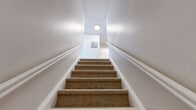Located at 498 Plaza Blvd in Morrisville, PA, this two-bedroom, one-bathroom residence offers a well-organized single-floor layout designed for comfortable everyday living. The kitchen is a standout feature, outfitted with white shaker-style cabinetry, a white subway tile backsplash, marble-look countertops, and a full suite of stainless steel appliances including a gas range, built-in microwave, dishwasher, and refrigerator. Light hardwood flooring runs through the kitchen and main living areas, creating a bright and cohesive aesthetic. The living room provides a clean, open space with natural light filtering in through the windows. The primary bedroom is a generously sized room featuring light hardwood floors, a wall-mounted air conditioning unit, baseboard heating, and a large window that brings in ample natural light. A convenient in-unit stacked washer and dryer is tucked neatly into a closet within the primary bedroom. The second bedroom is carpeted and features dual windows, a wall AC unit, and baseboard heating, offering a comfortable and well-lit retreat. The bathroom is finished with classic white subway tile surrounding the bathtub and shower. This residence combines practical amenities with a clean, updated aesthetic throughout.