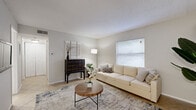 Located in Clearwater, Florida, this single-floor, two-bedroom, two-bathroom unit offers a functional and well-organized layout designed to maximize every square foot. The living room serves as the heart of the home, featuring light-toned tile flooring, a textured ceiling, and a large window that fills the space with natural light, creating a warm and inviting atmosphere. Neutral wall tones throughout contribute to a clean, cohesive aesthetic.

The combined kitchen and dining area is efficiently designed, featuring white cabinetry, white appliances including a range, microwave, dishwasher, and refrigerator, alongside a sink with a window view. Light tile flooring and ample cabinet storage make this a highly functional space. A dining area sits adjacent, providing room for everyday meals.

The primary bedroom is comfortably sized, carpeted for warmth, and includes a window for natural light. A notable feature is the in-unit stacked washer and dryer conveniently located within a closet in this room. The unit also includes three closets in total, one of which is a walk-in with wire shelving, providing generous storage options.

The bathrooms are finished with tile flooring and include a vanity with a sink, toilet, and a tub-shower combination. A hallway connects the rooms cohesively, completing this practical and comfortable Clearwater residence.