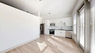 Located at 10221 Whistle Stop Lane in Frisco, TX, this thoughtfully designed one-bedroom, one-bathroom unit offers a clean, modern aesthetic throughout its efficiently laid-out single floor. Light wood-tone flooring flows seamlessly through each room, complementing the crisp white walls and trim that create a bright, airy atmosphere.

The entrance opens into a well-proportioned hallway featuring two closets, providing generous storage from the moment you walk in. The open-concept kitchen and living area serves as the heart of the unit, flooded with natural light from multiple windows. The kitchen is outfitted with white shaker cabinetry, dark countertops, a subway tile backsplash, and a full suite of stainless steel appliances including a refrigerator, range, microwave, and dishwasher.

The bedroom offers a comfortable retreat with a ceiling fan, light-filled windows, and access to a dedicated closet. The bathroom features wood-look flooring, white cabinetry with dark countertops, and a full tub-shower combination with tile surround. Additional conveniences include a dedicated laundry area, a utility room, and a private balcony — ideal for enjoying outdoor views. The overall design is clean, contemporary, and move-in ready.