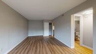 Located at 1 Kenilworth Court in Springdale, Ohio, this single-floor residence offers a clean, updated interior with a cohesive neutral color palette throughout. The living area is bright and open, featuring light-toned luxury vinyl plank flooring and a large window that fills the room with natural light, creating a welcoming and airy atmosphere.

The kitchen is well-appointed with gray shaker-style cabinetry, granite countertops, a stainless steel sink with a modern pull-down faucet, a subway tile backsplash, and black appliances. The efficient layout maximizes counter and storage space, with direct access to an exterior door.

The bedrooms offer comfortable accommodations, with one room featuring LVP flooring, a built-in closet, and neutral gray walls, while the other is finished with plush carpeting and a textured ceiling. A dedicated closet with shelving provides organized storage in the carpeted bedroom.

The bathroom is neatly finished with a gray vanity, granite-style countertop, LVP flooring, and a tiled tub-shower combination. The textured ceiling and neutral wall tones carry a consistent design language throughout the space.

Overall, the residence presents a move-in-ready interior with modern updates, practical storage solutions, and a straightforward single-level layout suited for comfortable everyday living.