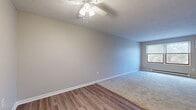 Located at 5325 13th St SW in Canton, Ohio, this single-floor, 2-bedroom, 1-bathroom unit offers a practical and comfortable layout. The living area features a combination of wood-style vinyl flooring and plush carpet, providing a warm and inviting atmosphere. Ceiling fans are installed throughout the unit, including in the living area and both bedrooms, contributing to year-round comfort. Neutral-toned walls and textured ceilings create a clean, understated aesthetic across all rooms.

The generously sized primary bedroom is one of the standout features of this unit, offering ample space for furnishings and personal use. The second bedroom is carpeted and includes a window that allows natural light and outdoor views, along with a baseboard heater. A dedicated closet with built-in wire shelving provides practical storage within the primary bedroom.

The kitchen is equipped with warm wood cabinetry, light countertops, a double stainless steel sink, and a white range, offering efficient functionality. The layout transitions smoothly from the carpeted living area through a hallway connecting the bedrooms, bathroom, and entry. Overall, the unit presents a straightforward, functional design well-suited for everyday living.