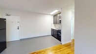 Located at 304 S Second Ave in Highland Park, NJ, this 1-bedroom, 1-bathroom unit offers a clean and functional single-floor layout. The open living and kitchen area features a seamless transition between warm hardwood flooring and neutral grey tile, creating a clear distinction between spaces. The kitchen is equipped with dark cabinetry, a black gas range, built-in microwave, and a full-size refrigerator, providing all essential appliances in a compact, efficient footprint. The living area is bright and open, finished with crisp white walls and clean baseboards throughout.

The bedroom is a comfortable, well-proportioned retreat with warm hardwood floors, soft neutral walls, and two windows that allow ample natural light to fill the space. A baseboard heating unit ensures year-round comfort, and a closet provides convenient storage.

The bathroom features a full soaking tub and shower combination, finished with large-format white wall tiles and accented by a decorative mosaic tile border near the ceiling. A window fitted with blinds brings in natural light while maintaining privacy. The overall aesthetic of the unit is clean, understated, and move-in ready, making it a practical and comfortable residence in Highland Park.