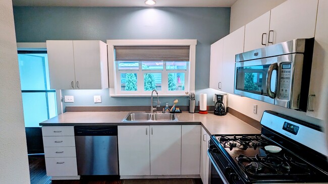 Full equipped kitchen - newly painted, gas oven/stove, dishwasher. - 4751 NE Prescott St