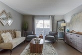 Located at 400 Winchester Trl in Smyrna, Georgia, this single-floor residence offers a well-designed layout with a variety of functional spaces throughout. The kitchen is equipped with dark espresso cabinetry, stainless steel appliances including a refrigerator and range, granite-style countertops, and a peninsula breakfast bar with barstool seating — ideal for casual dining or entertaining. The living area features warm wood-look flooring, neutral gray walls, and a comfortable, welcoming atmosphere with ample room for furnishings. The bedroom provides generous space with plush carpeting, a textured ceiling, and a wide sliding-door closet with built-in shelving and hanging rods. A dedicated office or flex room with carpeted flooring and a window offers versatility for work-from-home needs. The bathroom includes a white vanity with under-cabinet storage, a large mirror, and a full tub-shower combo with classic tile surround. A separate in-unit laundry area accommodates a full-size washer and dryer with additional overhead shelving. Throughout the residence, a cohesive neutral color palette and practical finishes create a clean, move-in-ready environment suited for everyday living.