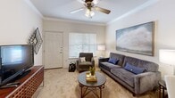 Located at 2808 S 28th Pl in Rogers, Arkansas, this single-level, one-bedroom, one-bathroom residence offers a well-organized and efficiently designed floor plan. The combined kitchen and living room area forms the heart of the home, creating an open, connected atmosphere. The living room features warm neutral carpet, crown molding, a ceiling fan with light fixture, and a large window that allows natural light to fill the space. The kitchen is thoughtfully appointed with warm-toned wood cabinetry, a peninsula countertop, tile flooring, crown molding, black appliances including a gas range, microwave, and side-by-side refrigerator with water dispenser, along with a stainless steel sink. The bedroom offers a comfortable and restful retreat, complete with plush carpet, a ceiling fan, natural light from a window, and a dedicated closet for storage. The bathroom features tile flooring, a warm wood vanity with ample cabinet storage, a lighted mirror, and clean, neutral finishes. Crown molding and ceiling fans are consistent design elements found throughout the home, contributing to a cohesive and polished aesthetic. This residence combines practical functionality with inviting, well-maintained interiors.