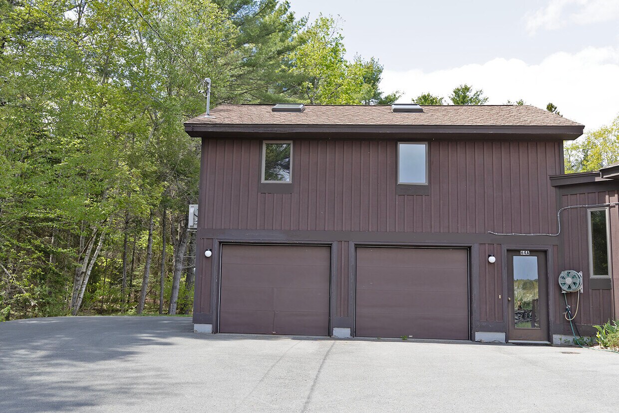 Upstairs apt over garage; front windows & 2 skylights; entrance door partially shows on right - 64 Gardner Rd