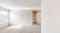Located at 1616 W Oak St in Denton, TX, this single-floor, one-bedroom, one-bathroom unit offers a compact and efficient layout designed for comfortable everyday living. The open living room is finished with neutral-toned carpet and painted in warm beige tones, creating a bright and welcoming atmosphere. Natural light filters in through the front entry area, and a ceiling fan with integrated lighting provides both comfort and illumination. The unit features a well-positioned kitchen equipped with a white range, granite-style countertops, and wood-look vinyl flooring, seamlessly connecting to the main living area. The bedroom is a comfortably sized private retreat, also finished with soft carpet and a ceiling fan with lighting. A window in the bedroom allows natural light to brighten the space, and a dedicated closet provides convenient storage. The bathroom is clean and functional, featuring a full tub-shower combo with white tile surround, chrome fixtures, and wood-look vinyl flooring that mirrors the kitchen. White panel doors and consistent neutral wall tones throughout the unit contribute to a cohesive and tidy aesthetic, making this a practical and well-appointed space in Denton.