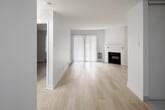 Located at 2757 Battleford Rd in Mississauga, this single-floor unit offers a clean, modern aesthetic throughout. Light-toned hardwood-style flooring runs continuously across the living spaces, contributing to a bright and cohesive feel. The living room serves as the centerpiece of the unit, highlighted by a white-surround fireplace with a classic mantel and a large sliding glass door fitted with vertical blinds, allowing natural light to fill the space while providing access to an outdoor area. Baseboard heating units are present along the walls, ensuring year-round comfort.

The bedroom areas are well-proportioned, featuring the same light flooring, crisp white walls, and textured ceilings. Each room offers a calm, neutral palette suited for a variety of uses. Structural beam details add subtle architectural interest in some rooms.

The kitchen is thoughtfully designed with a two-tone cabinet scheme—dark espresso lower cabinets paired with white upper cabinets—complemented by light stone-look countertops and a white subway tile backsplash. Stainless steel appliances, including a range and over-the-range microwave, complete the functional cooking space. The unit also includes in-suite laundry. Overall, the space presents a clean, updated interior with practical amenities.