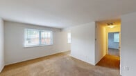 Located at 104 Richards Dr in Wilmington, DE, this one-bedroom, one-bathroom unit offers a practical and well-organized single-floor layout. The living room is a standout feature, providing generous open space with wall-to-wall carpeting and multiple windows that invite abundant natural light, creating a bright and welcoming atmosphere. The layout flows seamlessly from the living area into the hallway, connecting the key spaces throughout the unit. The kitchen is equipped with warm oak cabinetry extending to the ceiling for ample storage, a stainless steel sink, a full-size refrigerator, and a range with overhead ventilation — all set on durable tile flooring. The spacious primary bedroom features plush carpeting, a dedicated window with blinds for natural light and privacy, and convenient access to two closets, offering excellent storage capacity. The full bathroom includes a tub-shower combination with classic white tile and pink accent trim, a wood-vanity with under-sink storage, a mirror cabinet, and tile flooring. Additional highlights include a utility room and a total of four closets distributed throughout the unit, ensuring practical storage solutions. The clean, neutral interior palette and carpet throughout the main living areas provide a comfortable and move-in ready environment.
