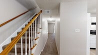 Located at 9205 Cedar Springs Pl in Louisville, KY, this two-story home offers three bedrooms and three full bathrooms across two evenly distributed floors. The layout flows from a welcoming entrance through a hallway and up a staircase connecting both levels. The kitchen features white cabinetry, light countertops, black appliances including an electric range and dishwasher, and light hardwood-style flooring, providing a clean and functional cooking space. The primary bedroom is generously sized, finished with plush carpeting, a ceiling fan, and a walk-in closet with built-in shelving. Additional bedrooms are well-proportioned, each equipped with ceiling fans; one features light hardwood-style flooring with a bright window, while another offers carpeting and sliding glass door access to an outdoor area. All three bathrooms maintain a clean, neutral aesthetic — one includes a tub/shower combo with tile flooring, another features a vanity with a large mirror and tub, and a third offers a compact vanity with tile flooring. Neutral-toned walls and consistent finishes throughout create a cohesive, move-in-ready atmosphere. A dedicated closet and hallway round out this practical and comfortable home.