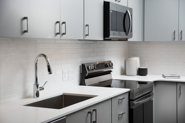 Modern kitchens with light grey cabinetry, white quartz countertops, and stainless steel appliances - Avalon Brighton