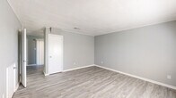 Located at 4814 Augusta St in North Little Rock, AR, this two-story home offers four bedrooms and one bathroom across two evenly divided floors. The interior features light gray walls and wood-look luxury vinyl plank flooring throughout, creating a cohesive and clean aesthetic. Textured ceilings add dimension to the main living areas, while crown molding provides a polished finishing touch in select rooms.

The kitchen is well-equipped with white cabinetry, gray laminate countertops, a stainless steel refrigerator, a black range with overhead ventilation, and a dishwasher. Vertical blinds on a large sliding door allow for natural light control. The bathroom includes a tub-shower combo with white subway tile surround, a vanity with a warm wood finish, and a clean, functional layout.

The four bedrooms are spread across both floors, each featuring the same neutral palette and vinyl plank flooring. Several rooms offer natural light through windowed with horizontal blinds, and at least one bedroom includes a built-in closet with shelving. An iron-railed staircase connects the two levels. The spacious primary bedroom provides a comfortable and private retreat. Overall, the home presents a freshly updated, move-in-ready interior with a practical and consistent design.